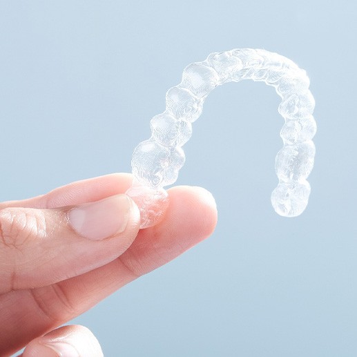 Patient holding clear aligner