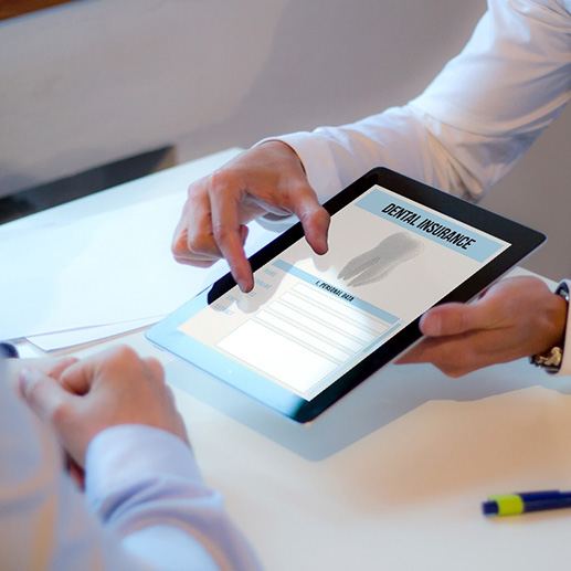 Patient reviewing dental insurance form on tablet