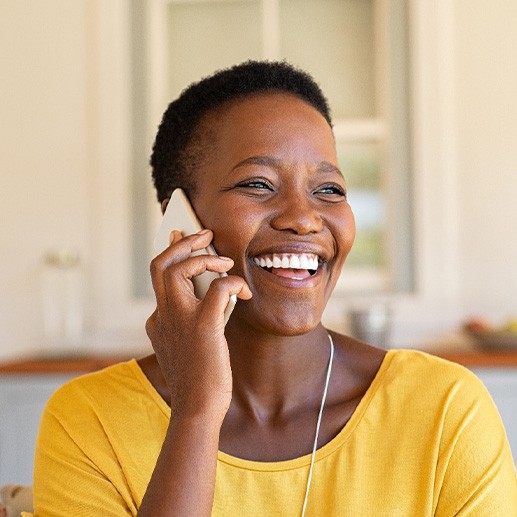 Woman smiling while talking on phone