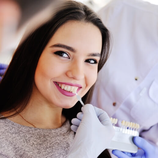 Young woman being fitted for veneers by cosmetic dentist