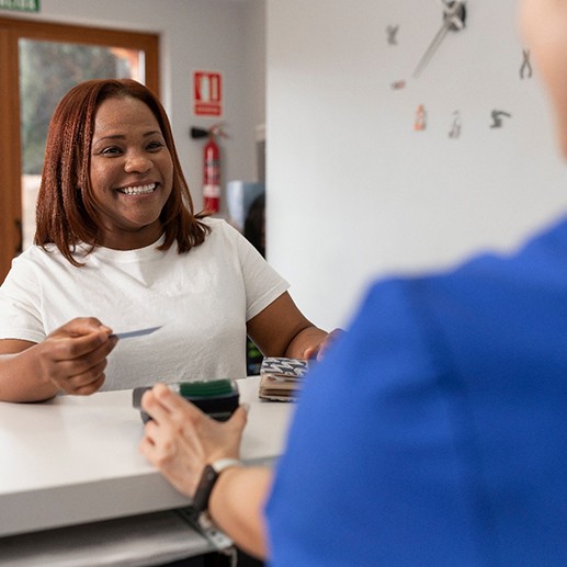 A woman paying for her dental treatment